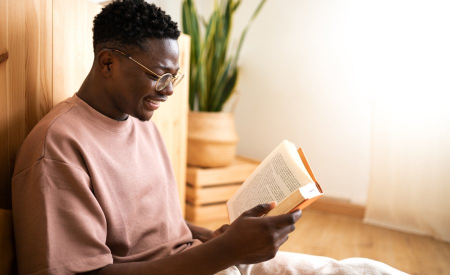 a man with glasses reading a book