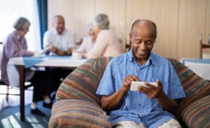 Smiling senior man looking at a smartphone