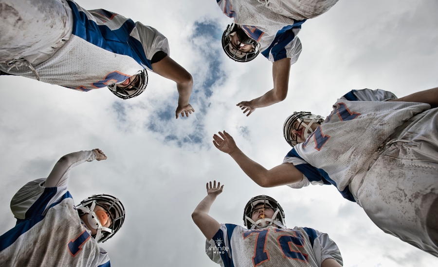 A group of football players,arms raised, view from below