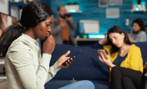 Multiracial friends using phones