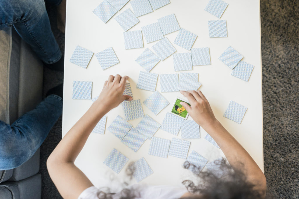 Girl playing memory game, overhead view