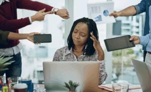 A women looking overwhelmed by multitasking at work