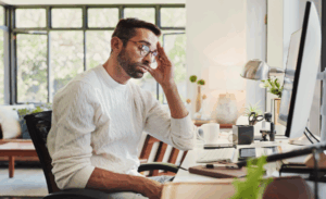 Tired, business man and computer in home office