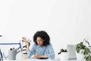 woman sitting at desk trying to focus on multiple tasks