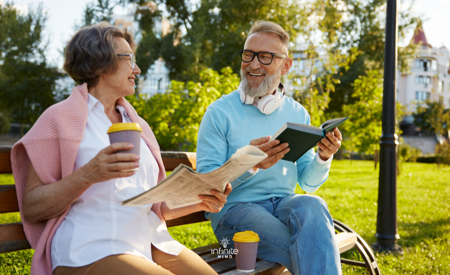 Concentrated man and woman couple reading on park bench