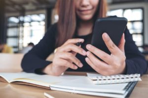 woman using smartphone for microlearning during a short study session