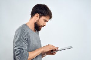 person focusing on tablet while using a brain training app to support processing speed