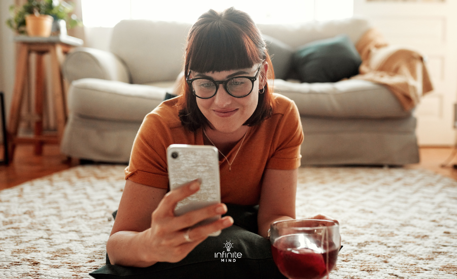 Woman Using Phone with a cup of tea at home