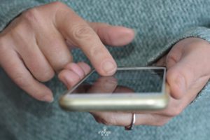 person using a smart phone for brain training games